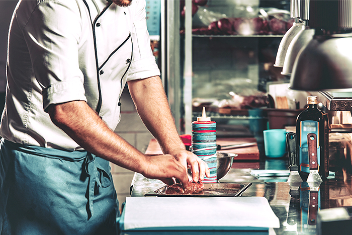 A chef preparing a meal for takeout