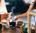 Employee scanning customer’s QR code on mobile phone.