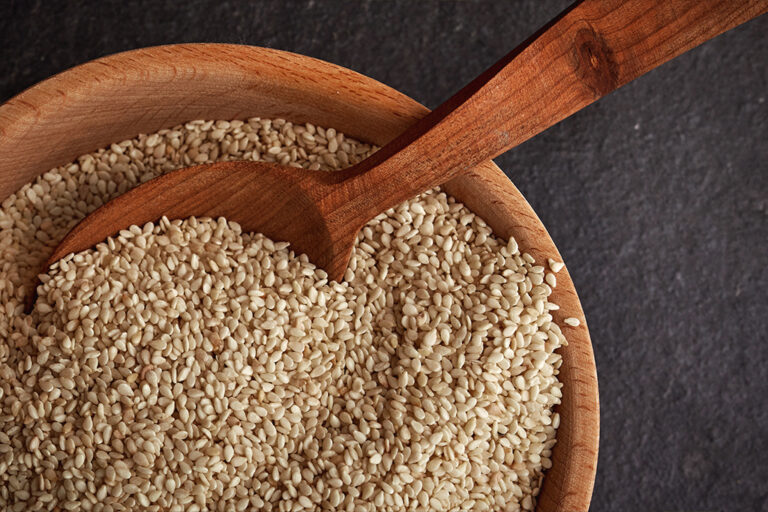 Wooden bowl of sesame seeds.